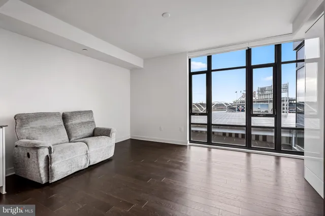 a living room with furniture and floor to ceiling window