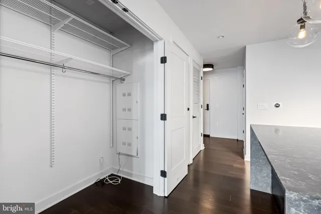 a view of a hallway with wooden floor