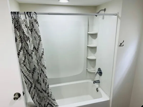 a bathroom with a bathtub and shower