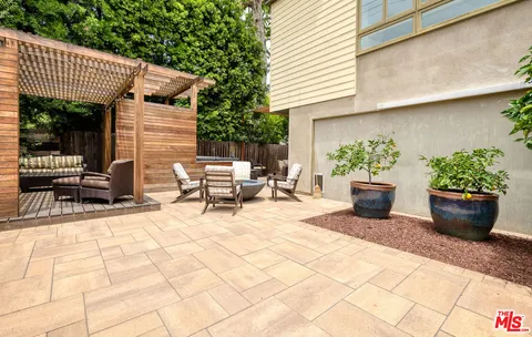 a view of a patio with chair and tables