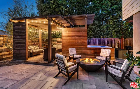 a backyard of a house with outdoor seating