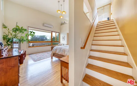 a view of entryway and hall with wooden floor