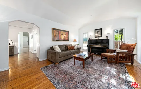 a living room with furniture or couch and a wooden floor