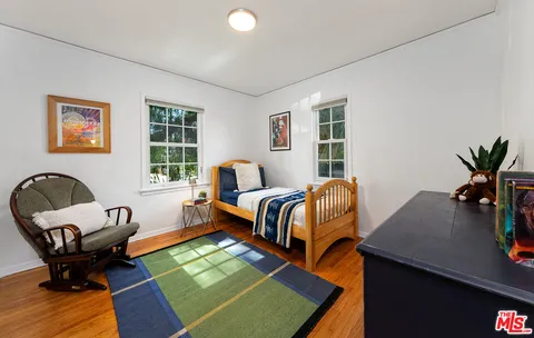 a bedroom with furniture and a window