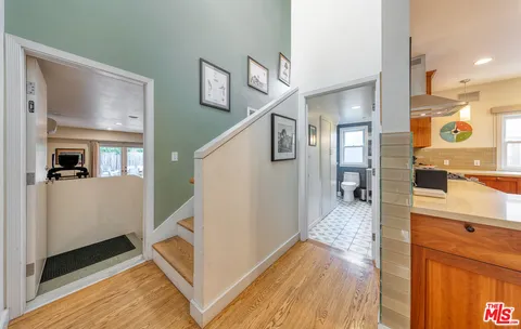 a view of a hallway view with wooden floor and staircase