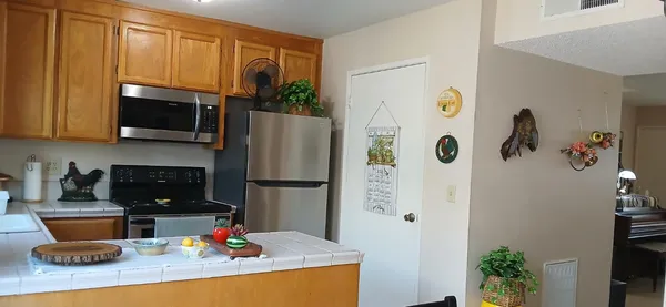 a kitchen with a refrigerator and a stove top oven