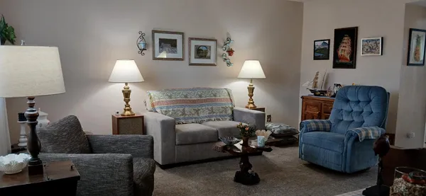 a living room with furniture and a lamp