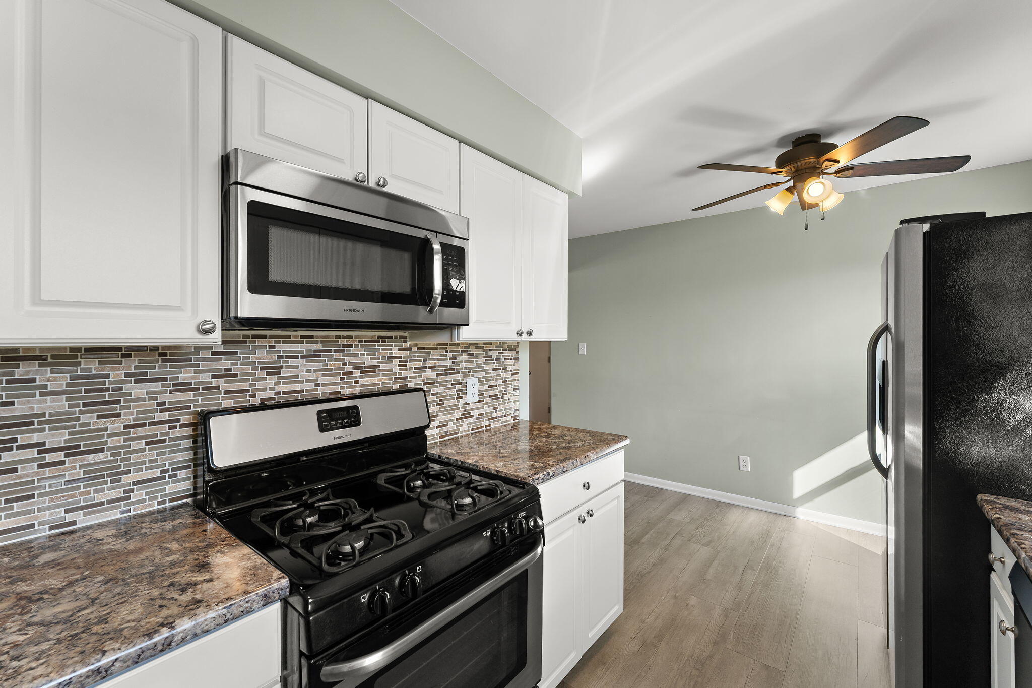 947 North Wood Street Griffith, IN 46319 - Photo 10 of 25 a kitchen with stainless steel appliances granite countertop a stove microwave and a refrigerator