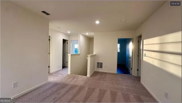 a view of a hallway with wooden shelves