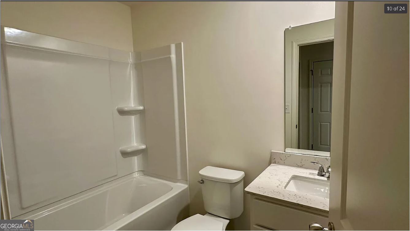 486 Grand Magnolia Street Jackson, GA 30233 - Photo 15 of 24 a bathroom with a sink a toilet and shower