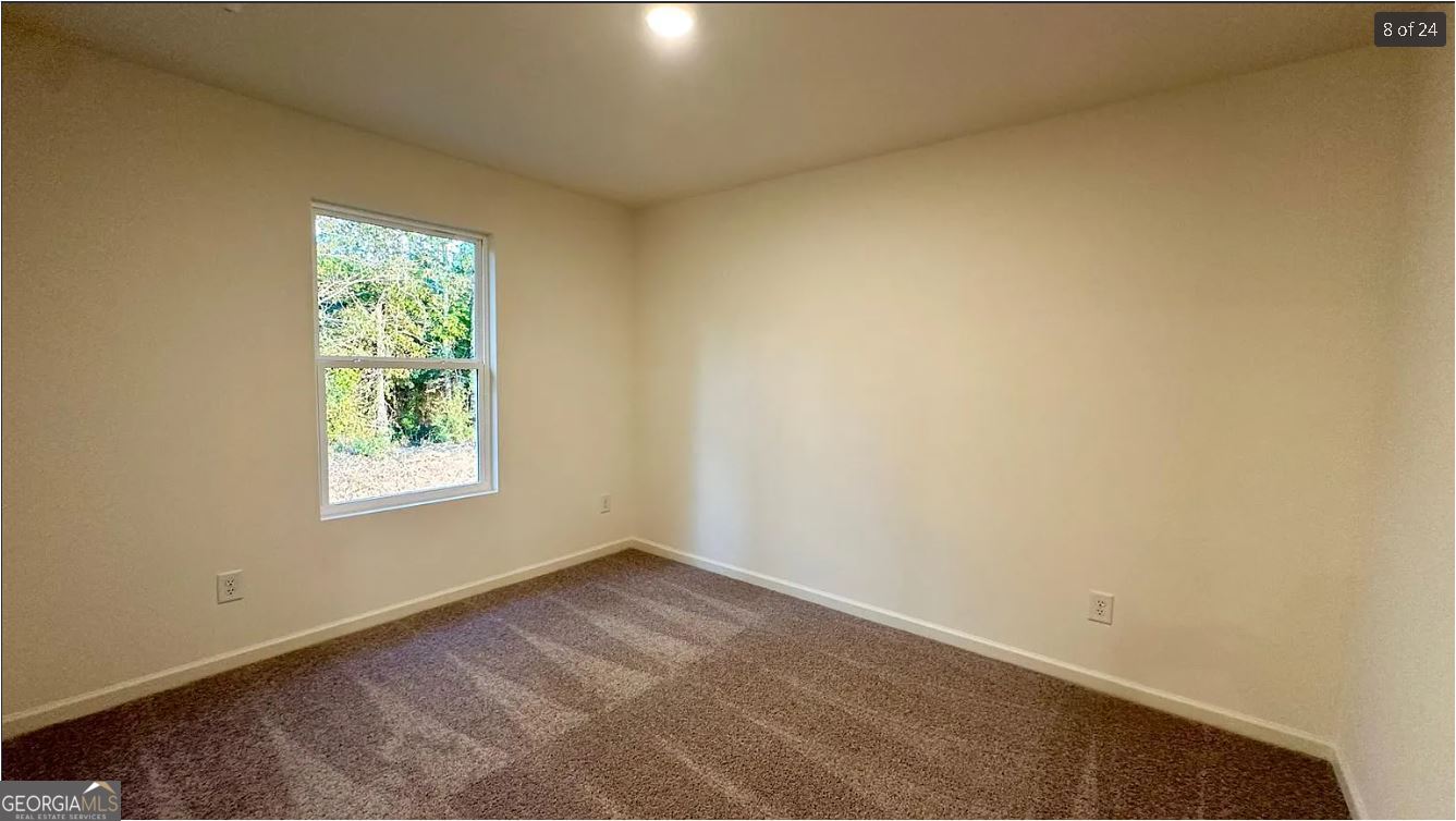 486 Grand Magnolia Street Jackson, GA 30233 - Photo 17 of 24 an empty room with a window