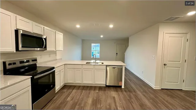 a kitchen with a sink stove and microwave