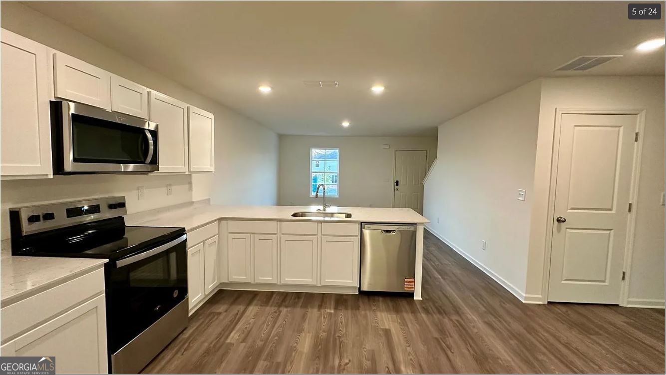 486 Grand Magnolia Street Jackson, GA 30233 - Photo 20 of 24 a kitchen with a sink stove and microwave