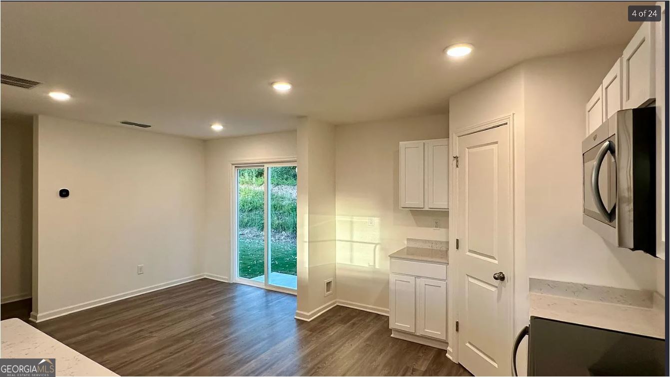 486 Grand Magnolia Street Jackson, GA 30233 - Photo 21 of 24 a view of hallway with wooden floor and electronic appliances