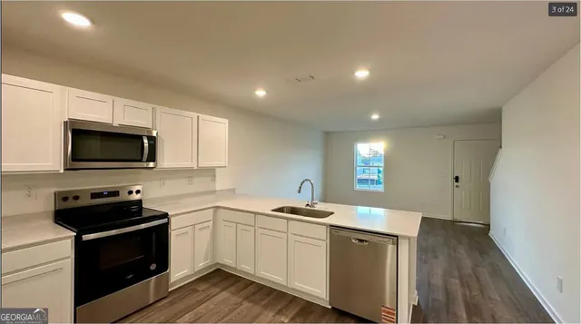 a kitchen with a sink stove and microwave