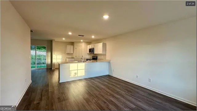 a kitchen with a white stove top oven and white kitchen island