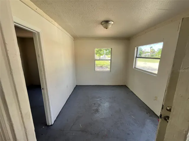 a view of an empty room and a window
