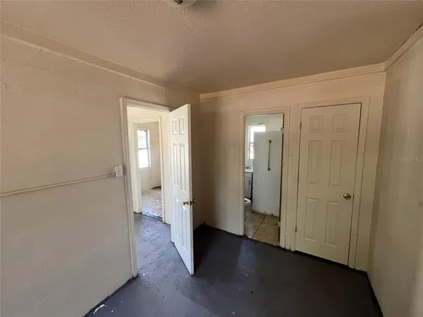 a view of a room with wooden floor