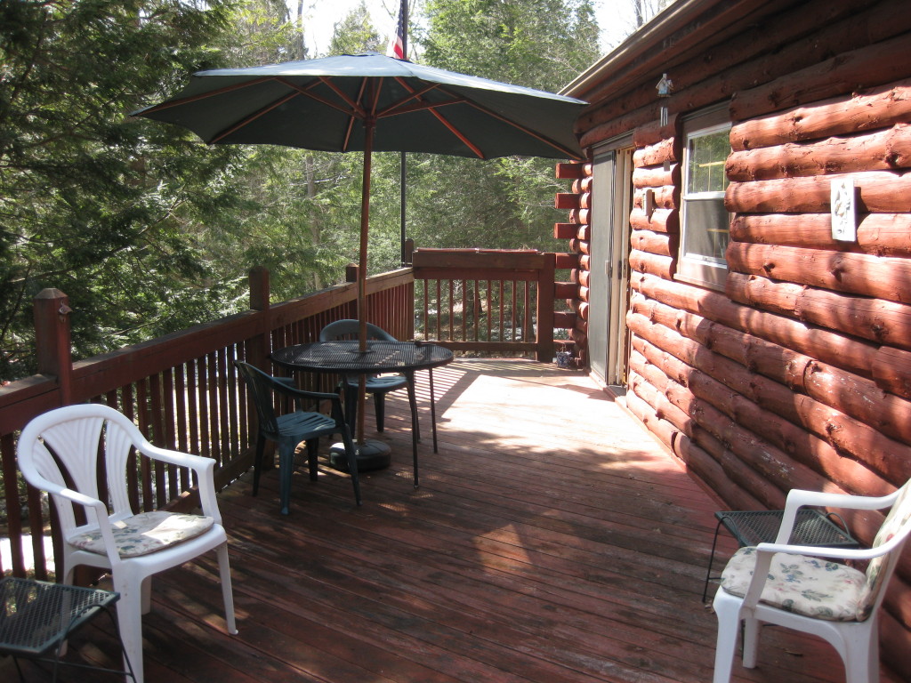 162 Chipman Road Middlefield, MA 01011 - Photo 3 of 11 a view of a chairs and table under an umbrella in the patio