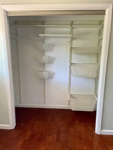 a view of water heater room with wooden floor