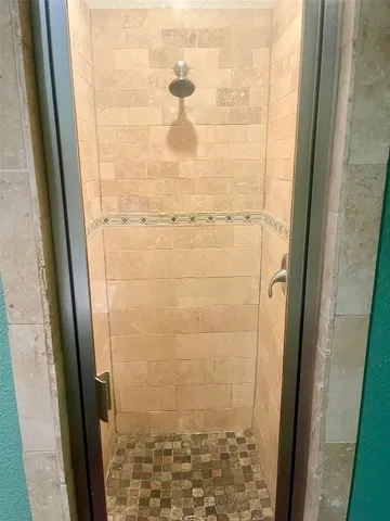 a bathroom with a glass door shower