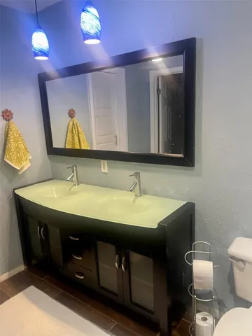 a bathroom with a toilet sink and mirror