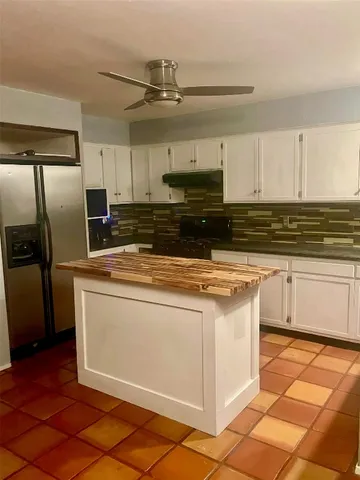 a kitchen with stainless steel appliances granite countertop a stove a refrigerator and a sink