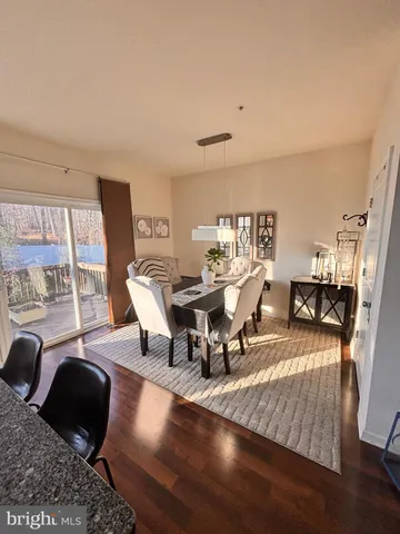 a view of a dining room with furniture and a large window