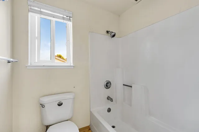 a bathroom with a toilet and shower