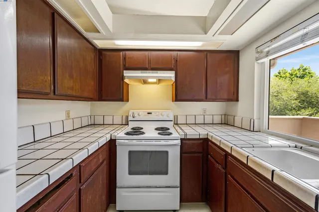 a kitchen with a sink stove and cabinets