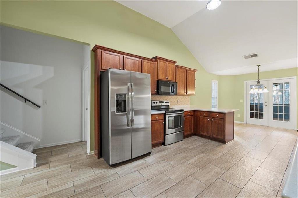 1218 Morgans Run Monroe, GA 30656 - Photo 6 of 39 a kitchen with stainless steel appliances granite countertop a refrigerator and a stove