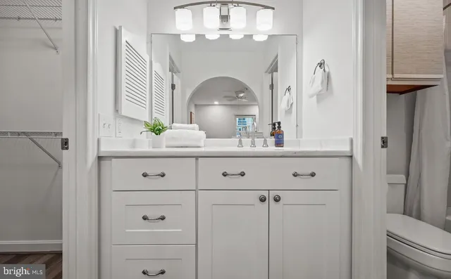 a bathroom with a sink mirror and vanity