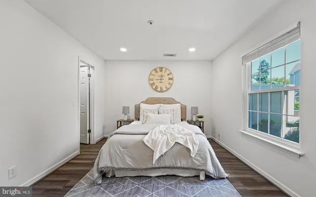 a large bedroom with a bed and a window