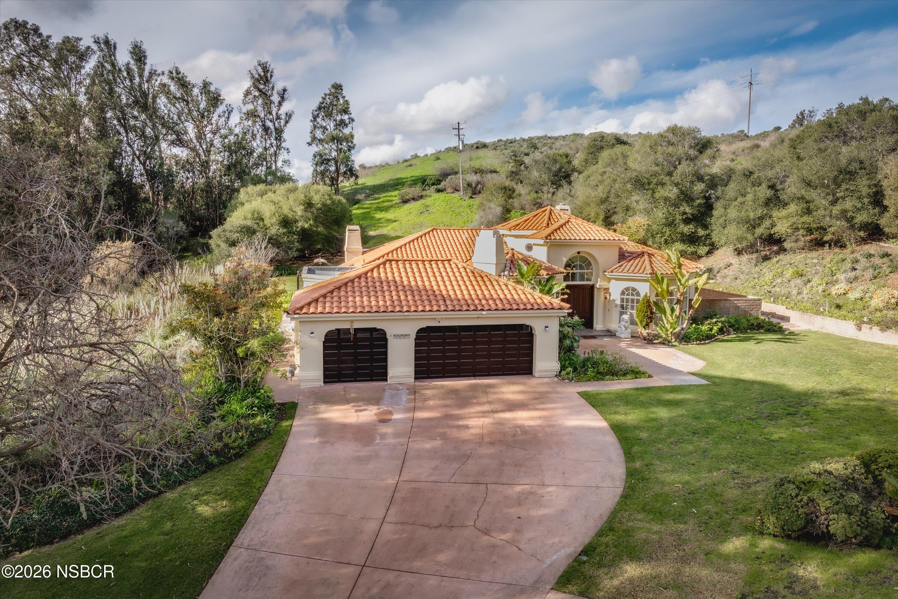 2655 Adobe Falls Road Lompoc, CA 93436 - Photo 6 of 51 a view of a white house with a yard and potted plants