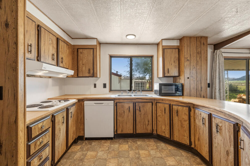 31410 Union Street Bonanza, OR 97623 - Photo 9 of 37 a kitchen with stainless steel appliances granite countertop a sink and cabinets