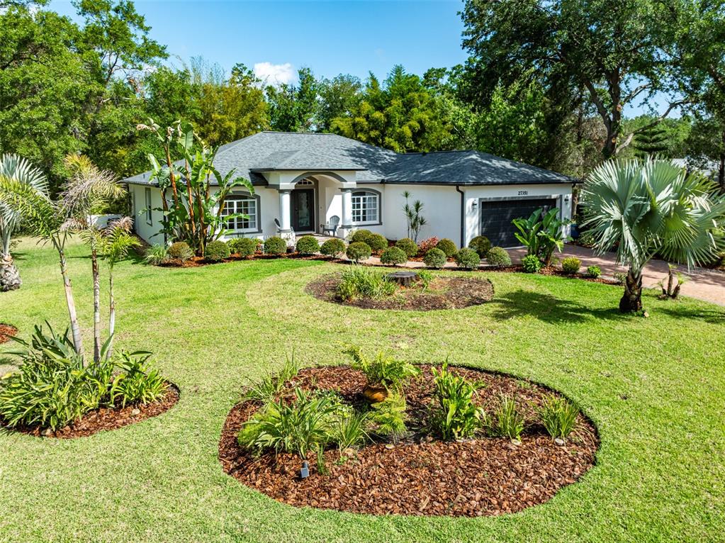 27351 Golf Course Loop Wesley Chapel, FL 33544 - Photo 1 of 1 a front view of a house with a yard table and chairs