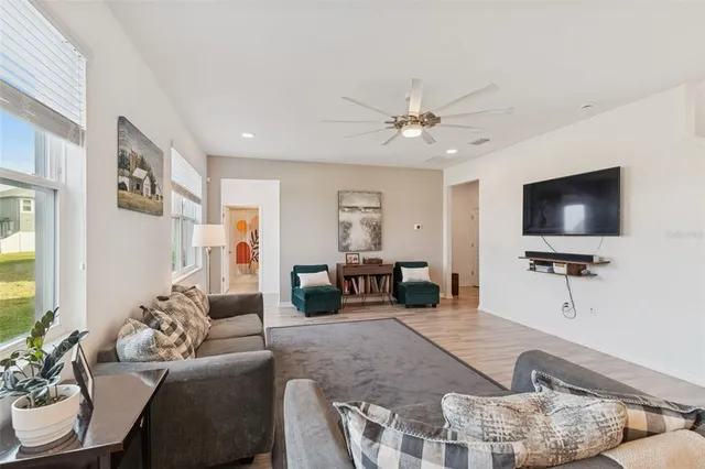 a view of a room that has a table and a chandelier