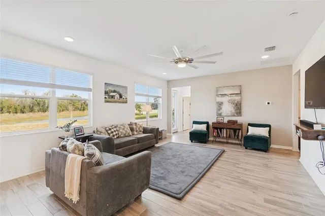 a bathroom with a granite countertop sink mirror vanity and toilet