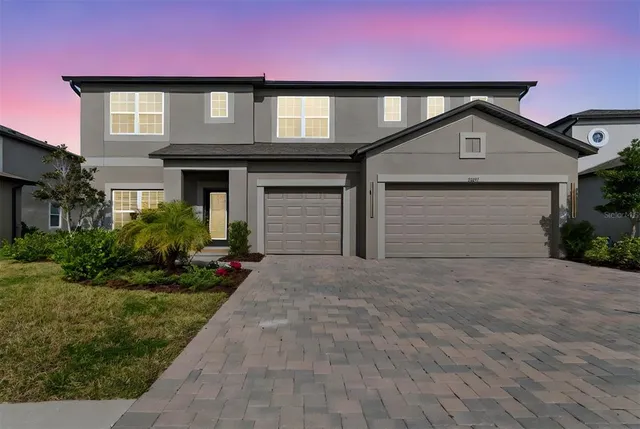 a front view of a house with a yard and garage