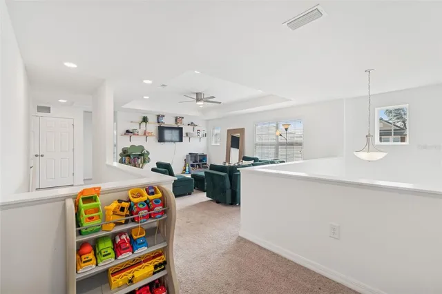 a spacious bedroom with a bed and a chandelier