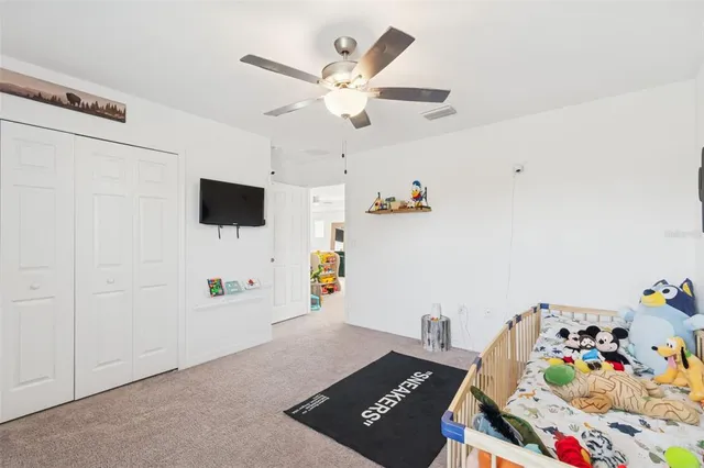 a view of a house with a yard and potted plants