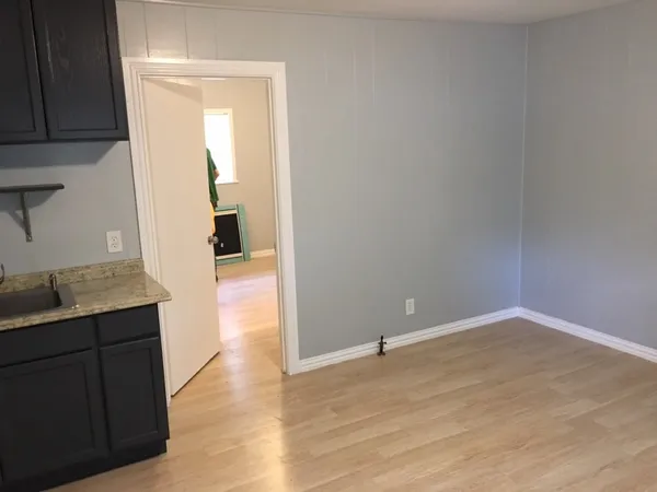 a view of hallway with wooden floor