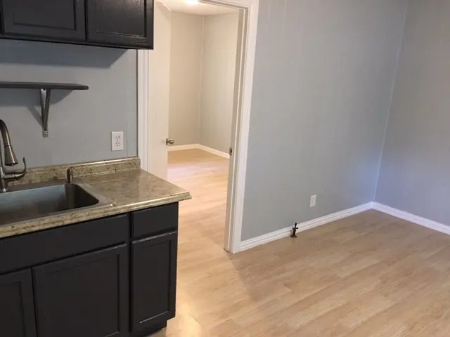 a kitchen with a sink and a refrigerator