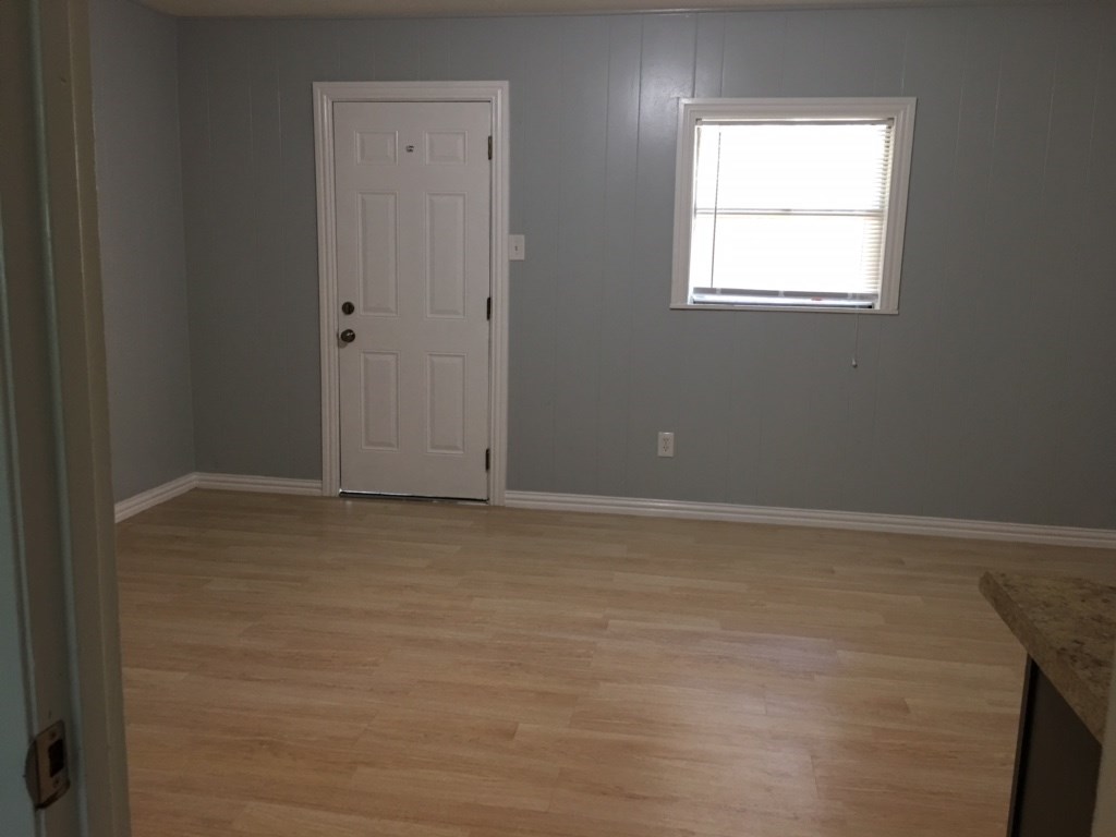 2018 Ave L 1/2, Unit 4 Huntsville, TX 77340 - Photo 4 of 6 an empty room with a window