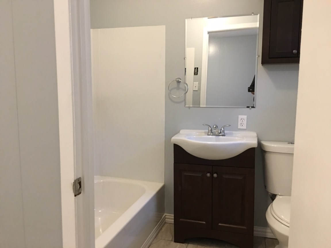2018 Ave L 1/2, Unit 4 Huntsville, TX 77340 - Photo 6 of 6 a bathroom with a sink toilet and vanity