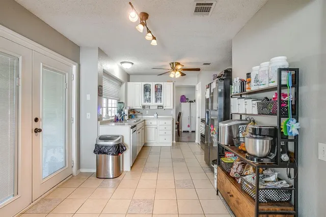 a open kitchen with cabinets and a stove