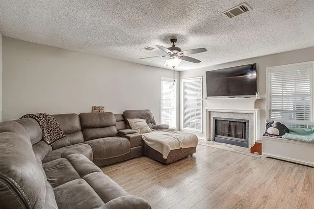 a living room with furniture fireplace and flat screen tv