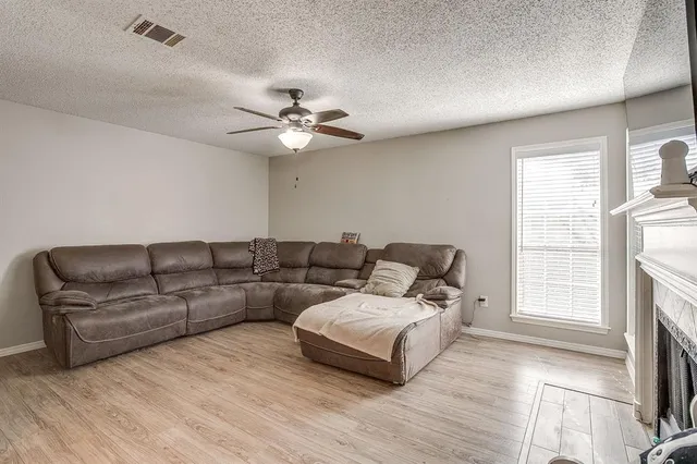 a living room with furniture and a fireplace