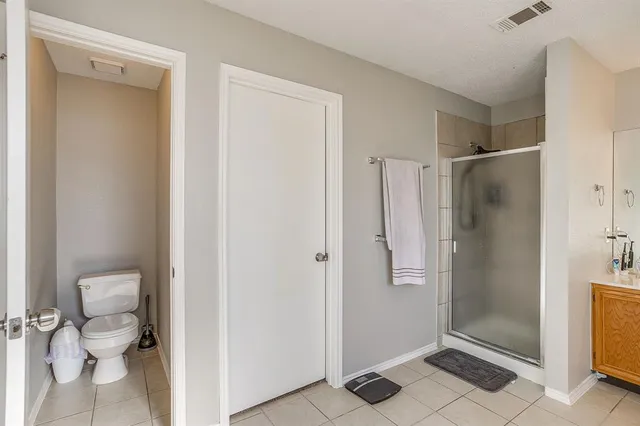 a bathroom with a shower and a toilet