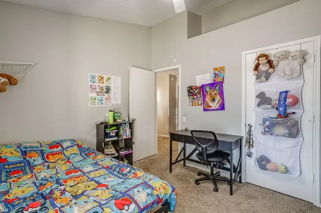 a bedroom that has a bed and a chair in it